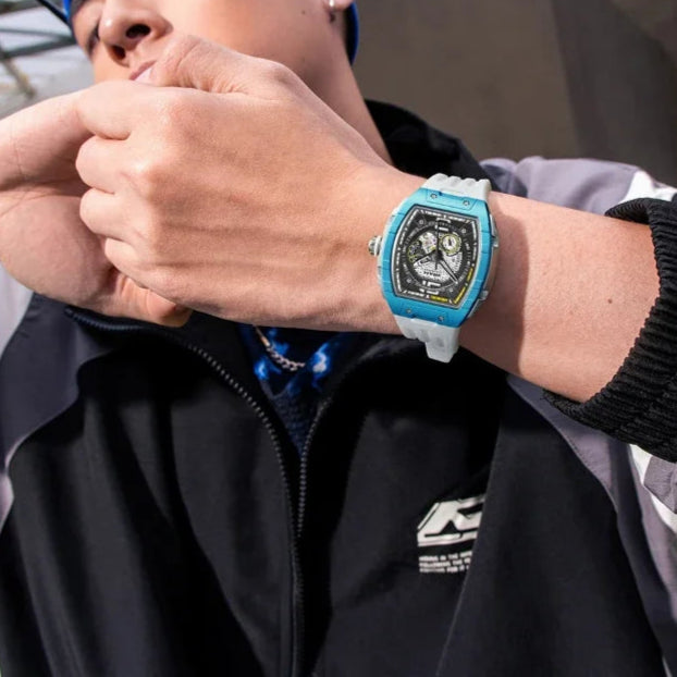 Lifestyle photo of a man wearing the Fairwhale 6002 VANTROX blue skeleton tourbillon automatic watch with white strap.