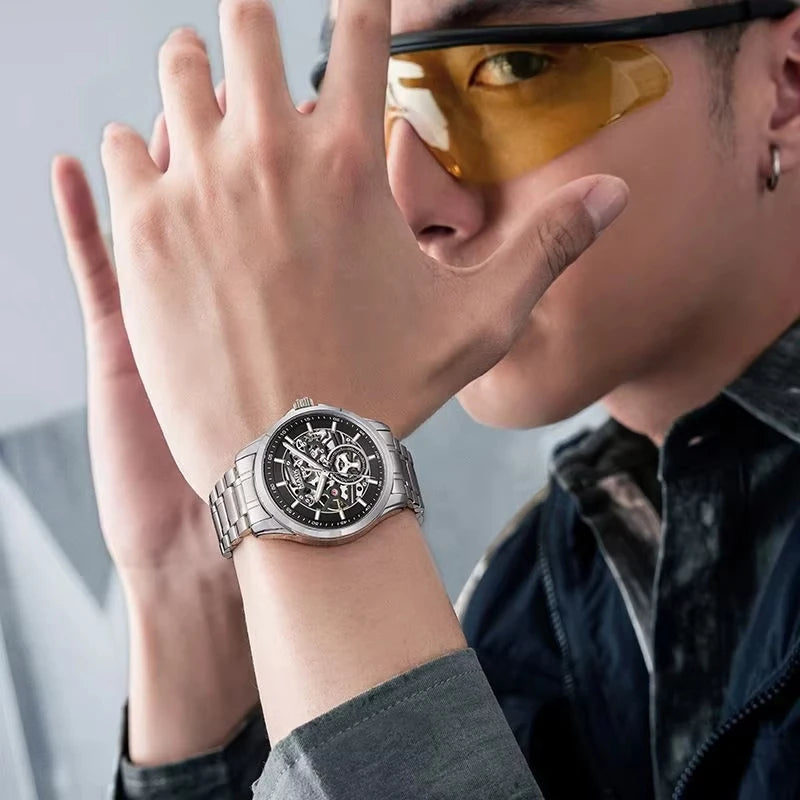 Lifestyle shot of Mark Fairwhale VORTEXA FW-6011 skeleton automatic watch worn with stainless steel strap, modern luxury wristwatch style.