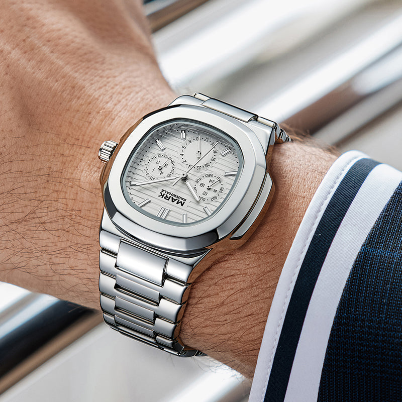 Mark Fairwhale 5019 LUMENIX silver watch worn on a man’s wrist in business attire.