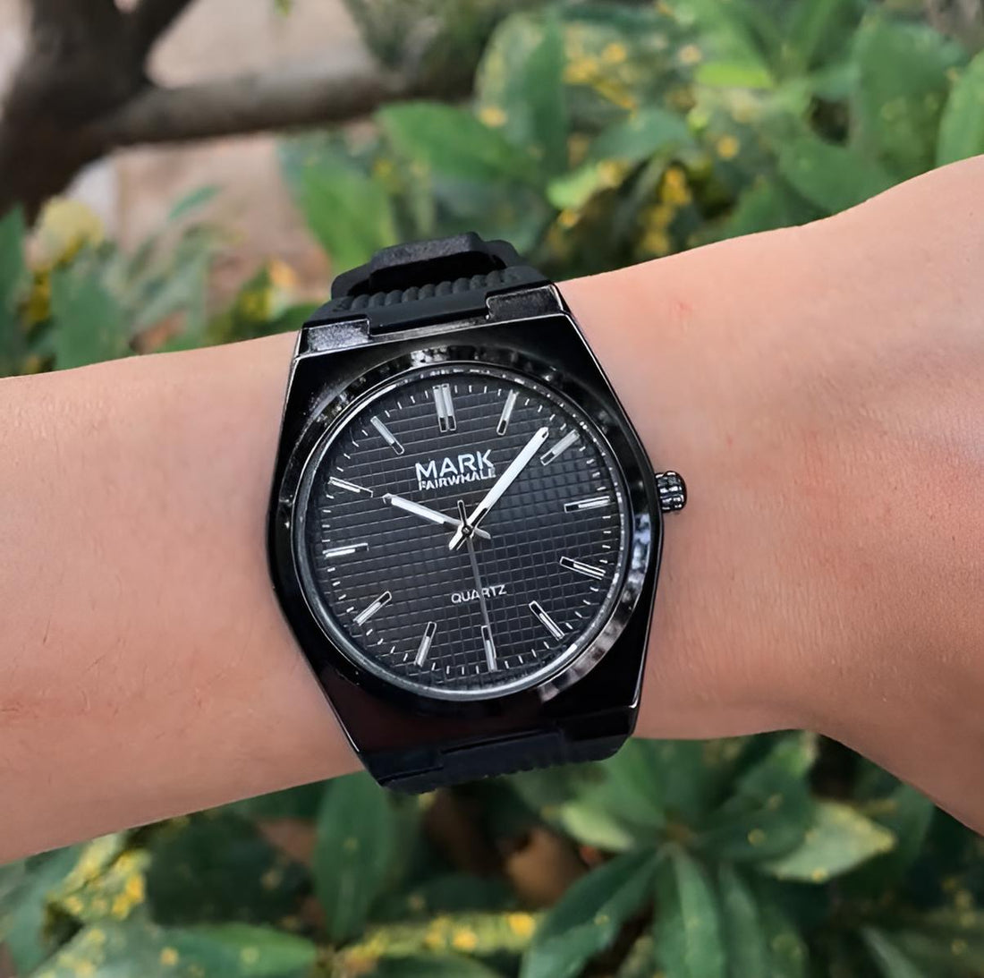 Mark Fairwhale STRAYA men’s quartz watch with black textured dial and luminous hands, shown on wrist with outdoor background