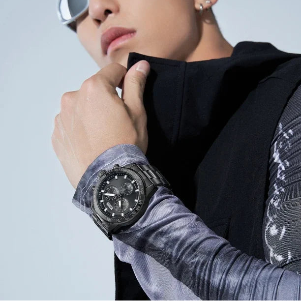 Model wearing Mark Fairwhale NOVEXA black chronograph watch with stainless steel strap.