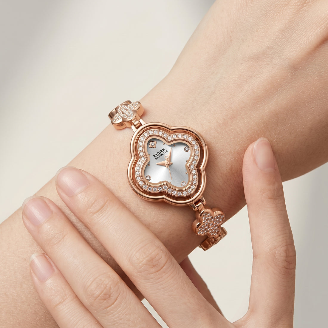 Rose gold heart-shaped watch on a wrist with a light background