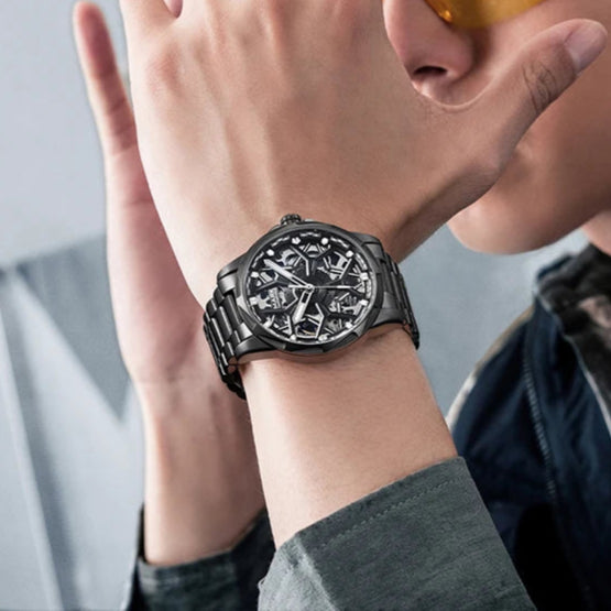 Luxury Mark Fairwhale FW-6800 AURENX skeleton watch on man’s wrist with black stainless steel strap
