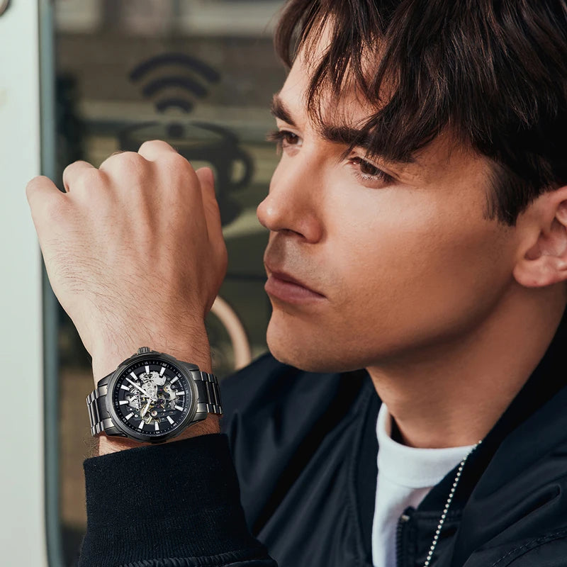 Mark Fairwhale 6950 AUREON luxury skeleton automatic watch worn by man, showcasing stainless steel strap and modern design.