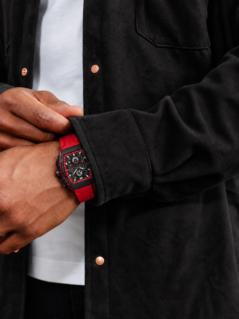 BOLTRON in Red on the wrist: a hand adjusts the cuff of a black overshirt worn over a white tee