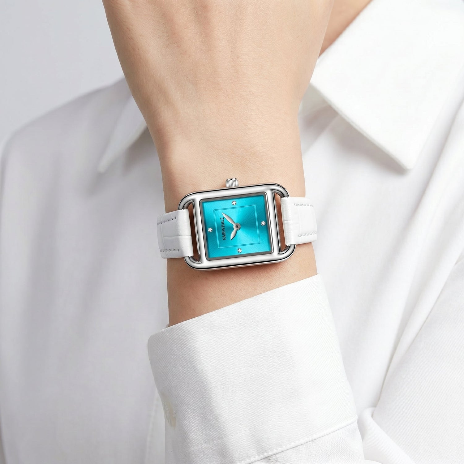 Fairwhale women's square watch turquoise dial white leather strap on wrist close up minimalist luxury style