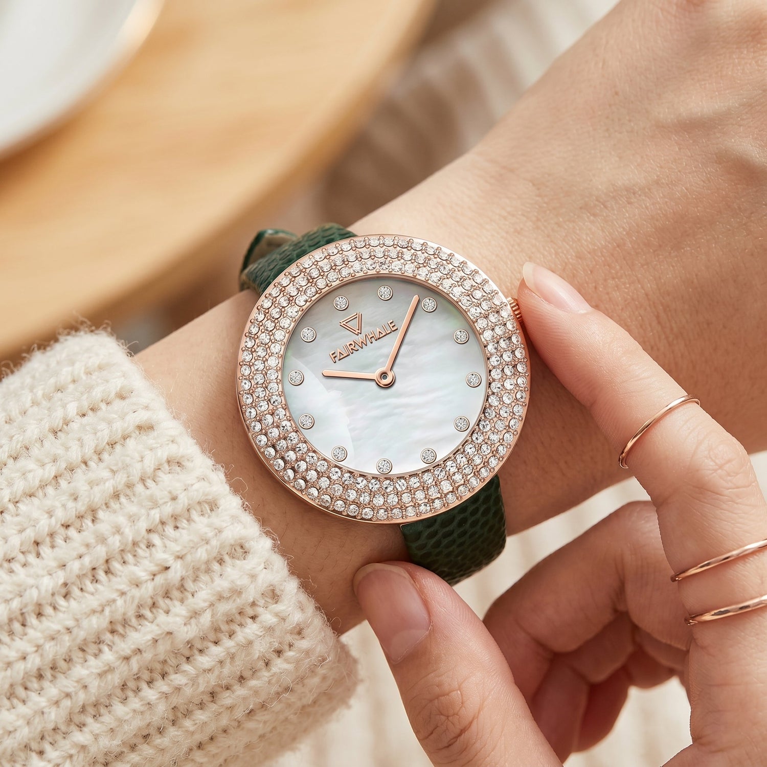 Luxury women’s rose gold diamond watch green leather strap wrist close-up