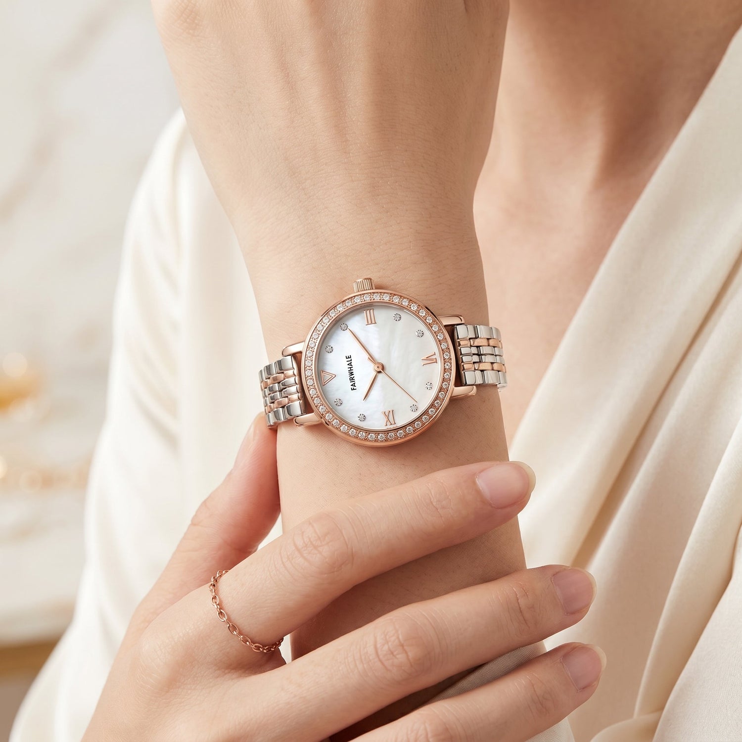 Fairwhale women's classic watch rose gold stainless steel bracelet on wrist with clear dial detail elegant ivory outfit