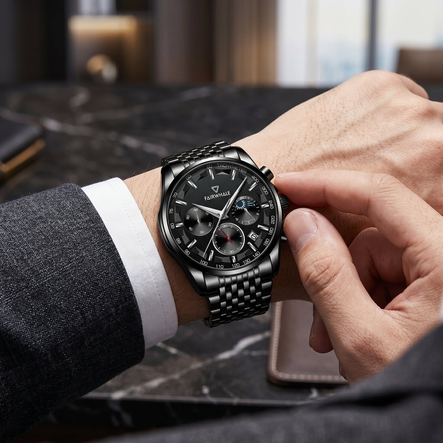 Mark Fairwhale men’s black chronograph watch with tachymeter bezel on wrist, luxury suit close-up