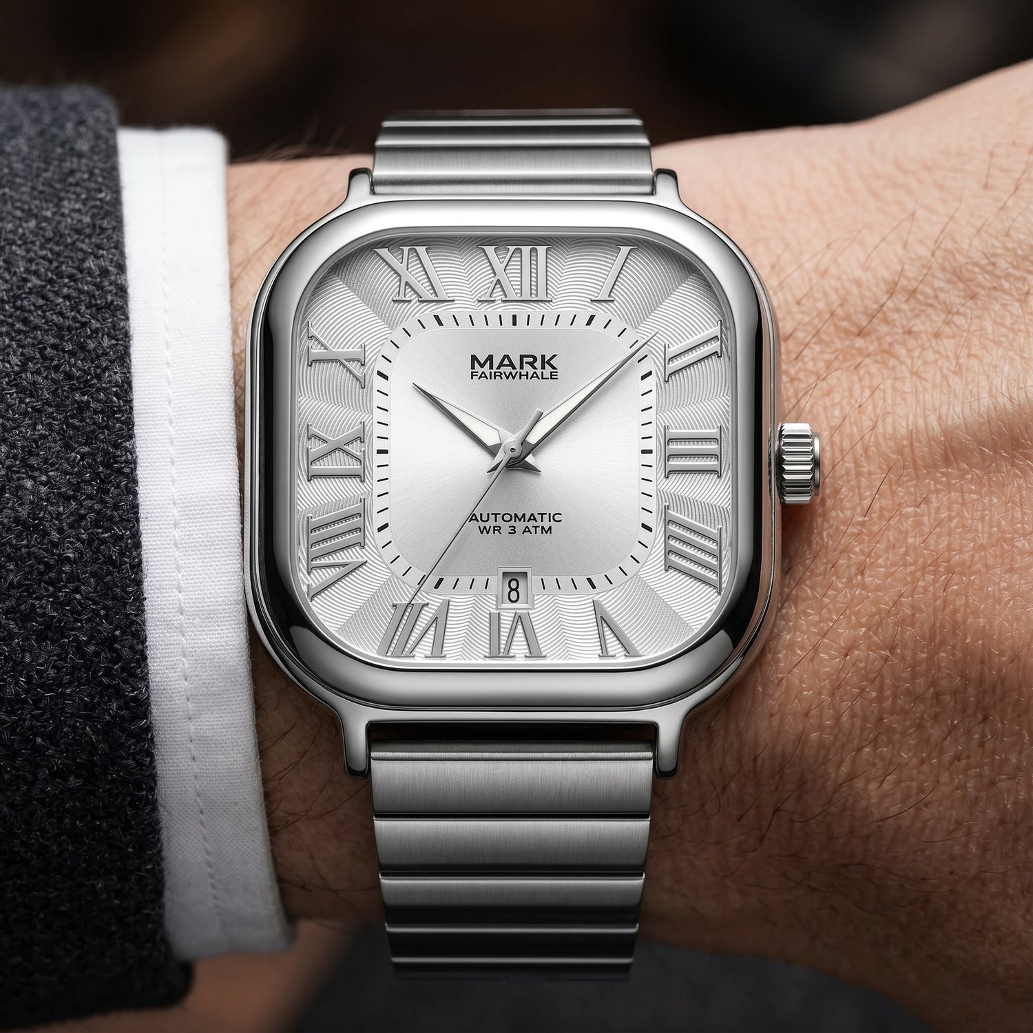 Mark Fairwhale men’s square silver watch with Roman numeral dial, stainless steel bracelet, wrist close-up