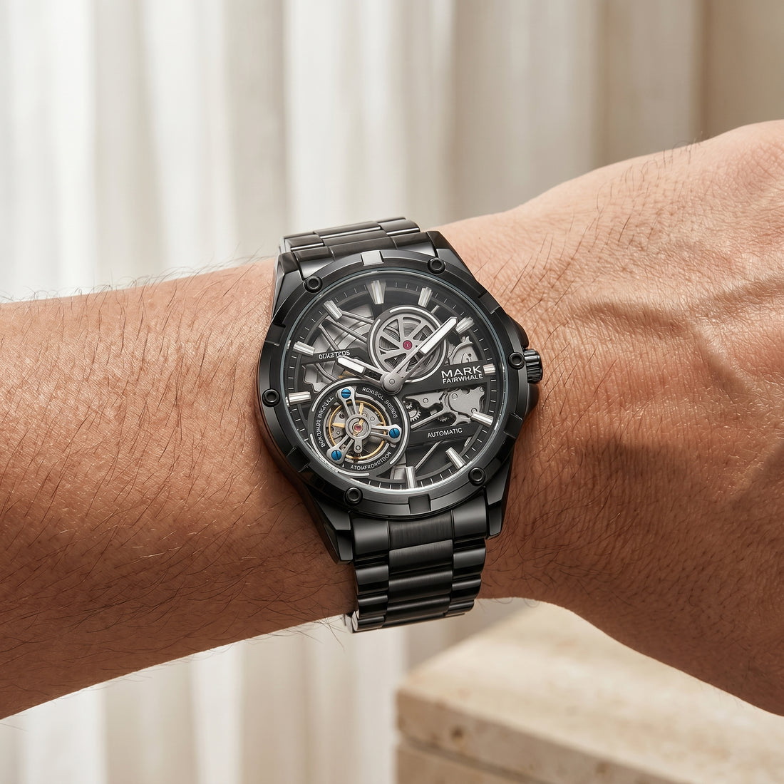 Black mechanical watch on a wrist with a blurred background