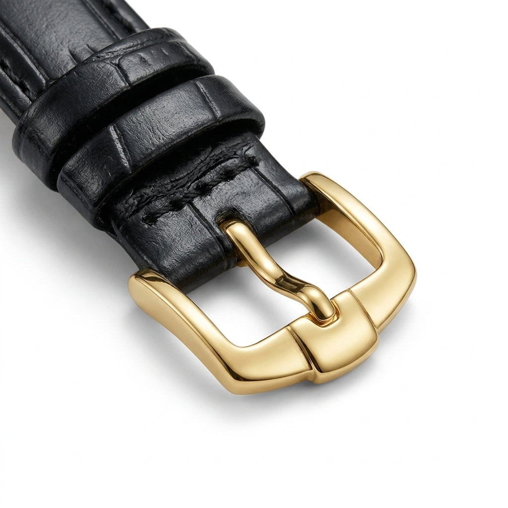 Black leather watch strap with a gold buckle on a light gray background