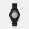 Black mechanical watch with open face on a white background