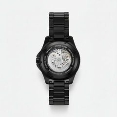 Black mechanical watch with open face on a white background
