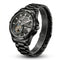 Black mechanical watch with transparent face on a white background
