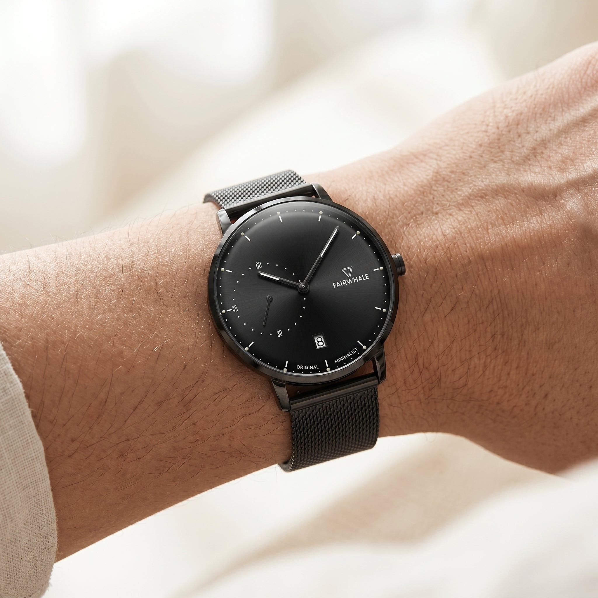 Black watch on a wrist with a blurred background
