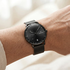 Black watch on a wrist with a blurred background