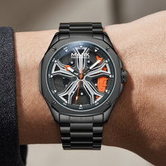 Black wristwatch with orange accents on a wrist against a neutral background