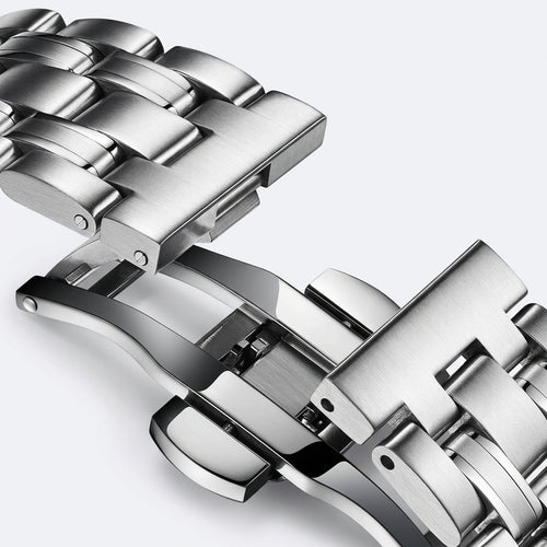 Close-up of a silver metal watch strap on a light gray background