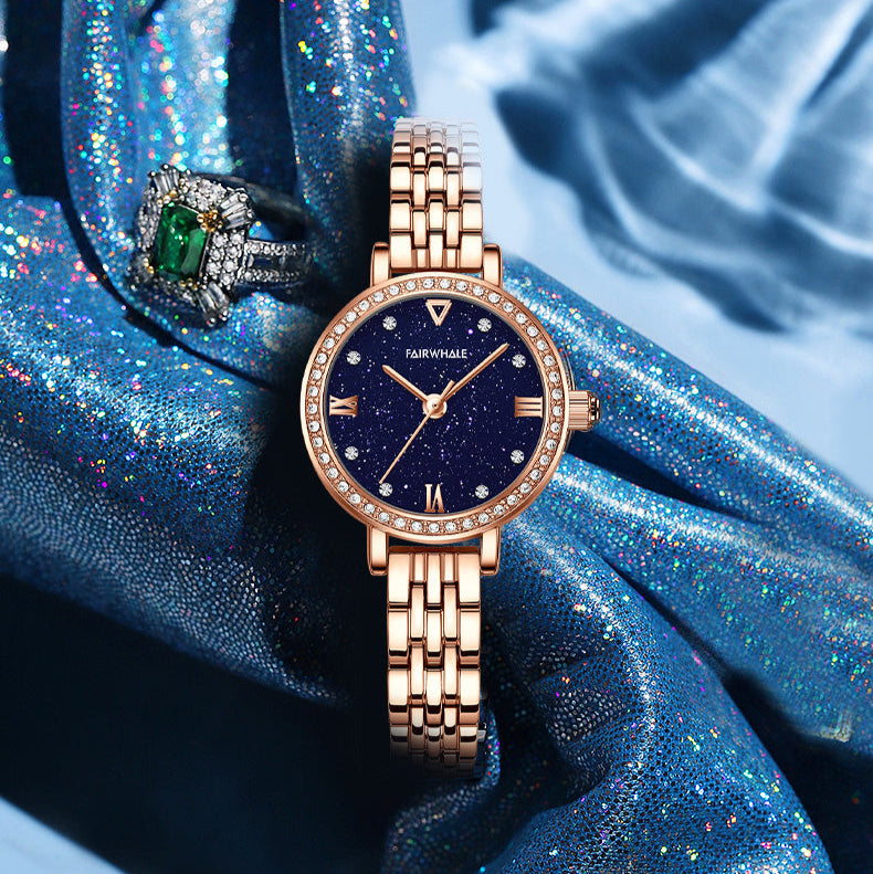 Close-up of Mark Fairwhale 3250 LUNAERA quartz watch showing rose gold crown, starry blue dial, and crystal-embellished bezel for luxury detailing