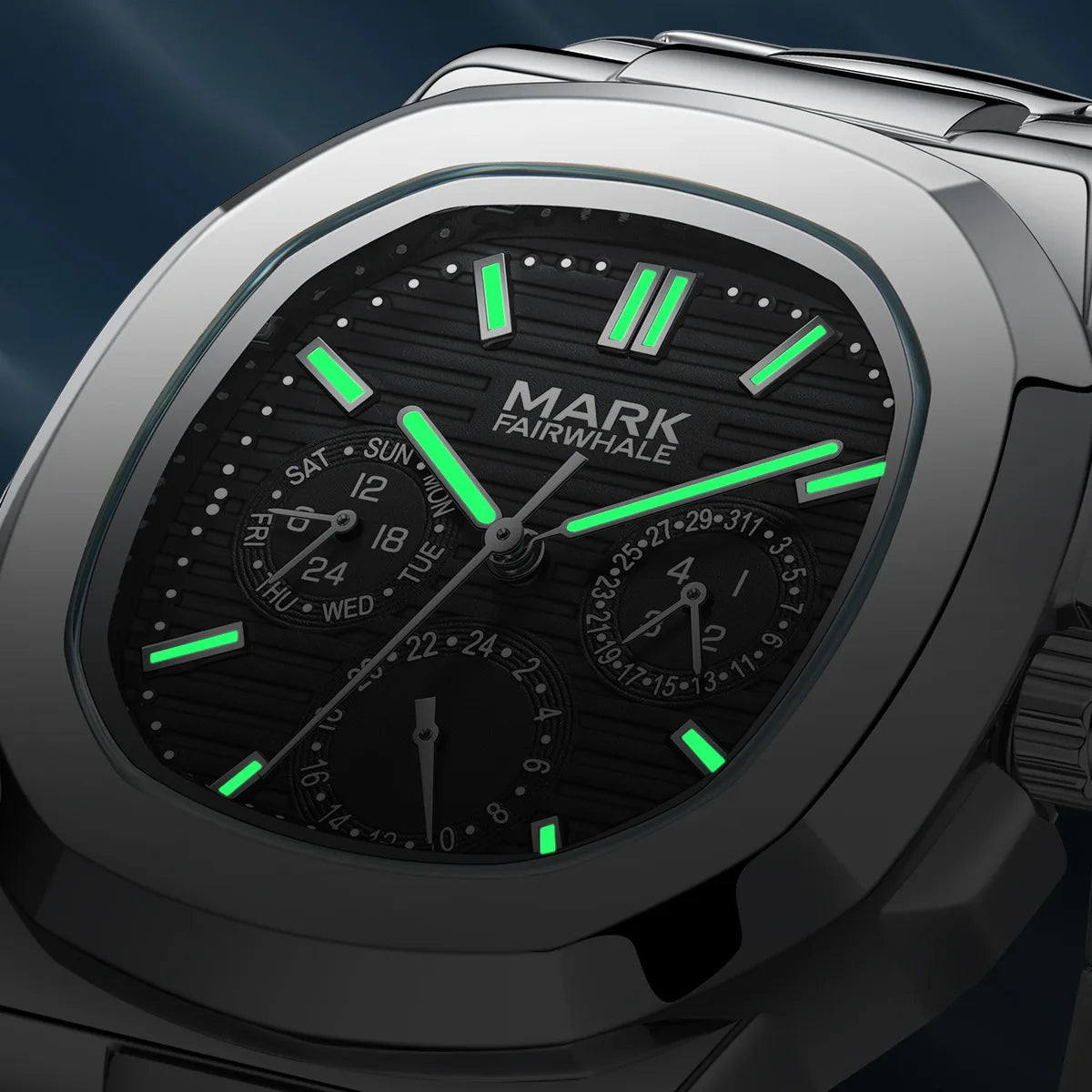 Close-up of Mark Fairwhale 5019 LUMENIX black dial glowing with luminous hands in low light.