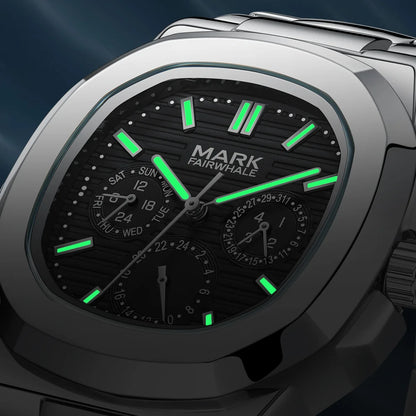 Close-up of Mark Fairwhale 5019 LUMENIX black dial glowing with luminous hands in low light.