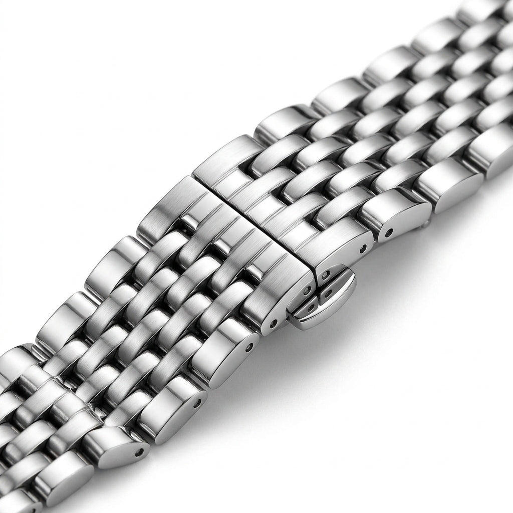 Close-up of a silver metal watch strap on a white background