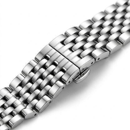 Close-up of a silver metal watch strap on a white background