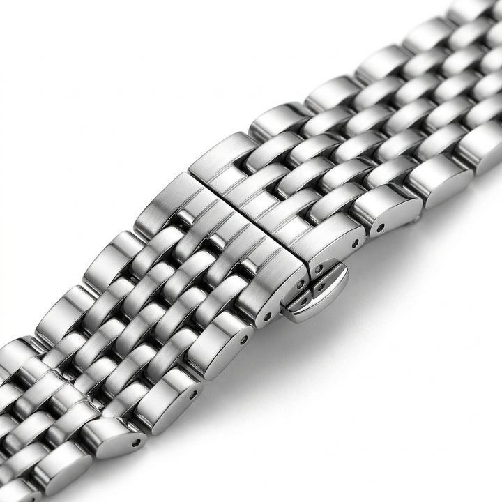 Close-up of a silver metal watch strap on a white background