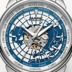 Close-up of a Mark Fairwhale automatic world watch dial with a silver-tone case, blue and silver globe map design, and city names around the outer ring.