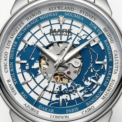 Close-up of a Mark Fairwhale automatic world watch dial with a silver-tone case, blue and silver globe map design, and city names around the outer ring.