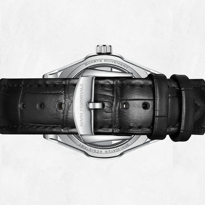 Close-up of a Mark Fairwhale watch with black leather strap and silver case on a white background