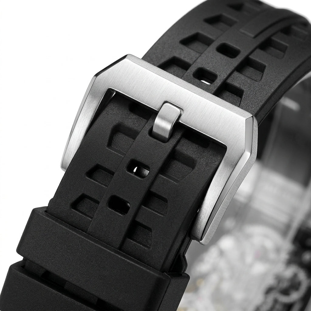 Close-up of a black watch strap with a silver buckle on a white background