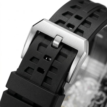 Close-up of a black watch strap with a silver buckle on a white background