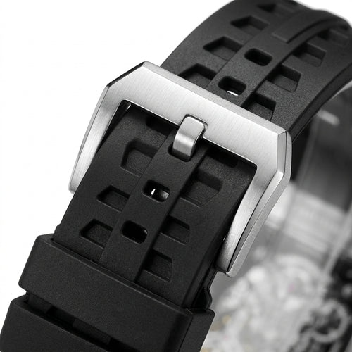 Close-up of a black watch strap with a silver buckle on a white background