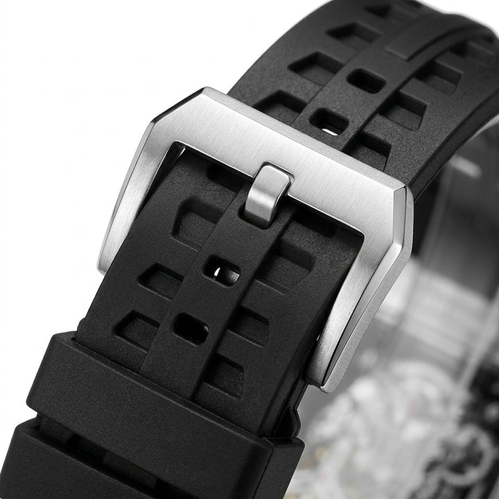 Close-up of a black watch strap with a silver buckle on a white background