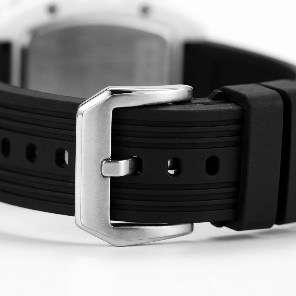 Close-up of a black watch strap with a silver buckle on a white background