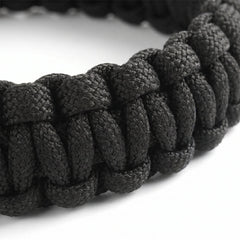 Close-up of a black braided bracelet on a white background