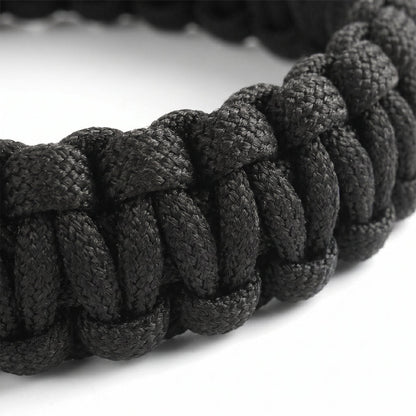 Close-up of a black braided bracelet on a white background