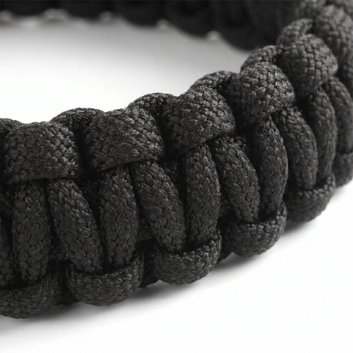 Close-up of a black braided bracelet on a white background