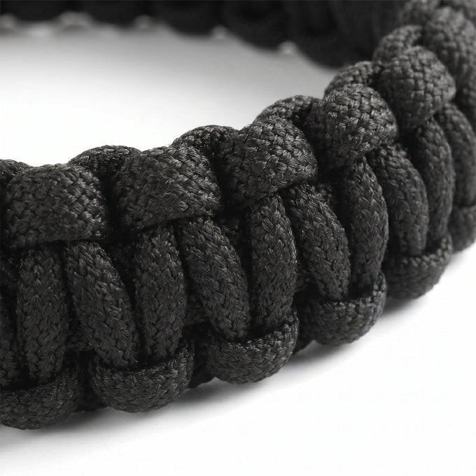 Close-up of a black braided bracelet on a white background