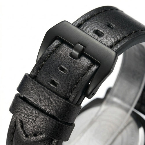 Close-up of a black leather watch strap with buckle on a white background