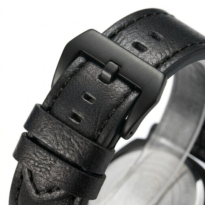 Close-up of a black leather watch strap with buckle on a white background