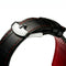 Close-up of a black leather watch strap with red stitching and a silver buckle on a white background.