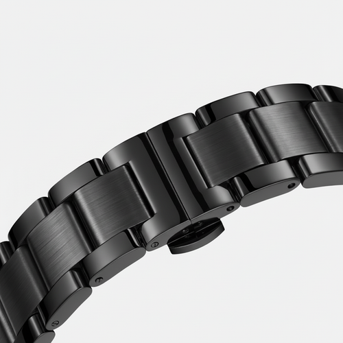 Close-up of a black metal watch strap on a light gray background