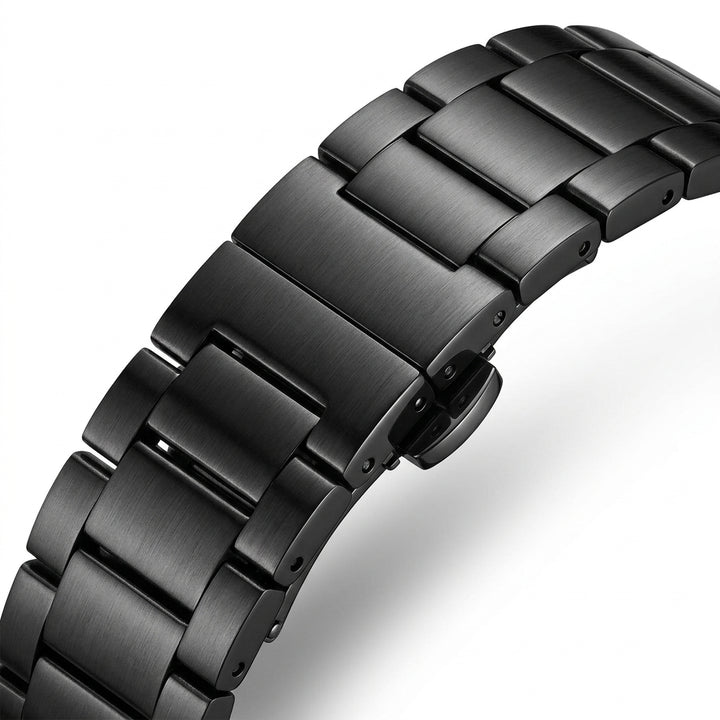 Close-up of a black metal watch strap on a white background