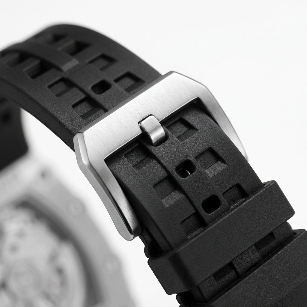 Close-up of a black waatch strap with a silver buckle on a blurred background