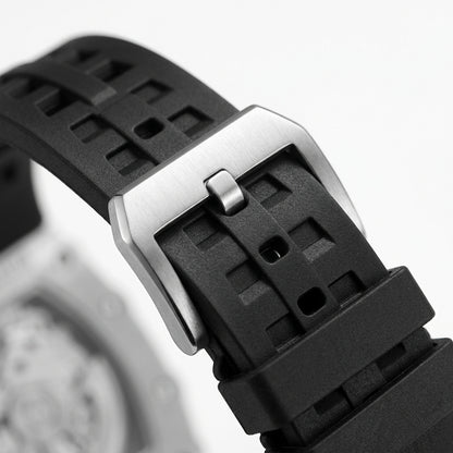 Close-up of a black waatch strap with a silver buckle on a blurred background