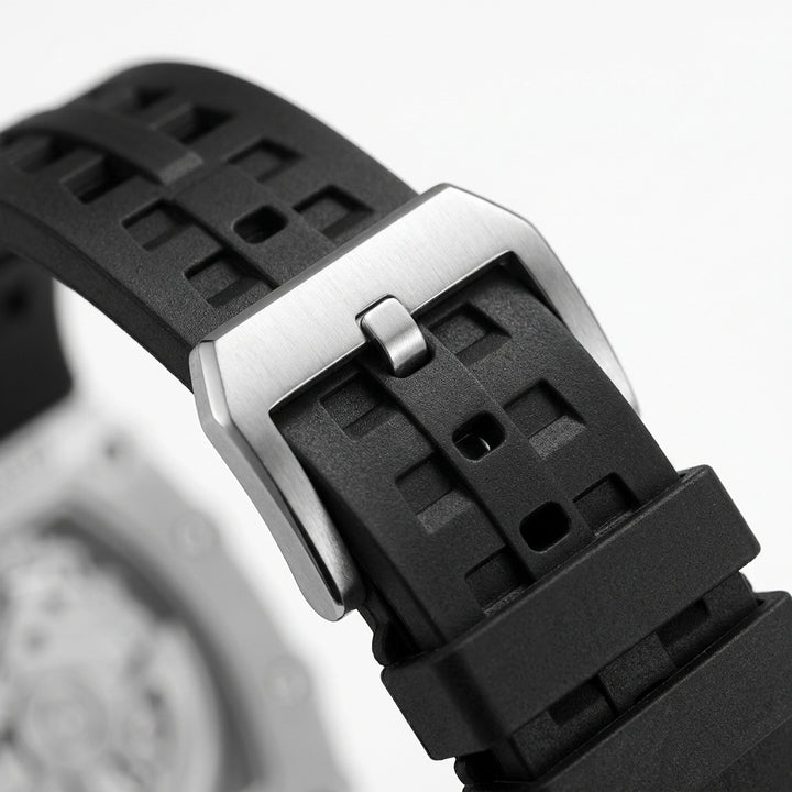 Close-up of a black waatch strap with a silver buckle on a blurred background
