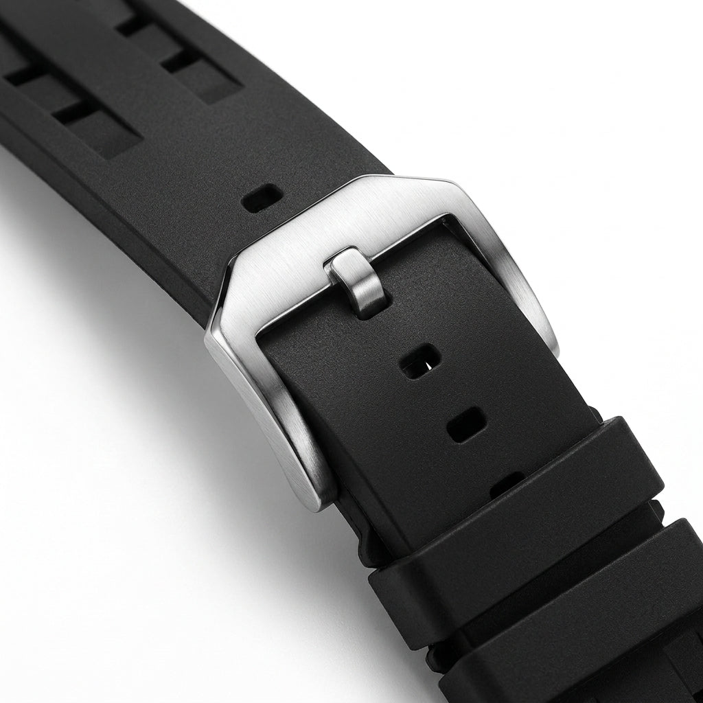 Close-up of a black watch strap with a silver buckle on a white background